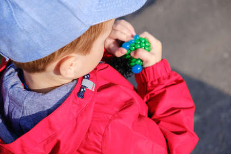 cute caucasian preschooler child playing hand made toy called slime.の写真素材