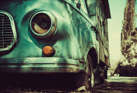 A rusty old abandoned truck sits derelict on the city streetの写真素材