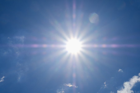Shining sun at clear blue sky with copy space, sunlight bright, sunny summer background