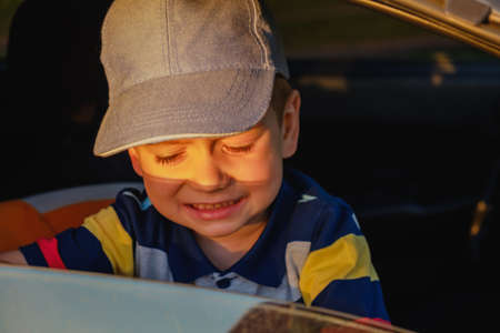 Portrait of cute child boy sitting in car seat. Child transportation safetyの写真素材