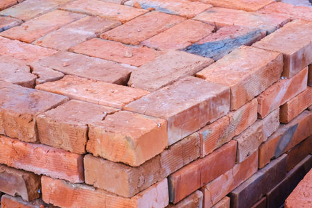 Building materials, red brick on a pallet, a pile of bricks, a background of bricks close-up.