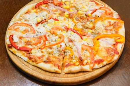 Delicious pizza served on wooden plate fast food with mozzarellaの写真素材