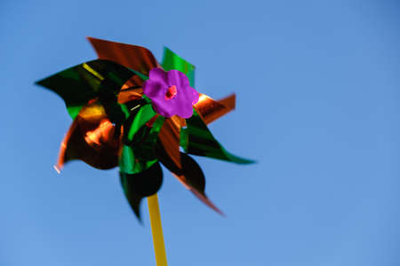 Colorful pinwheel against blue sky, children toyの写真素材