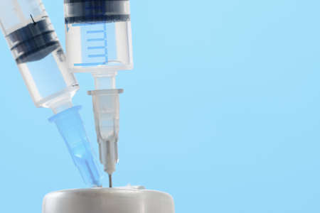 Medicine in vials and syringe , ready for vaccine injection , Cancer Treatment , Pain Treatment and can also be abused for an illegal use, on blueの写真素材