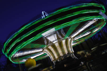 motion beautiful bright carousel in amusement park at nightの写真素材