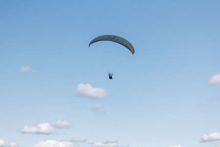 Paraglider flying sport, wing in blue skyの写真素材