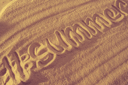 Summer time text with hashtag on sand. Concept on ocean beach. With copy space.の写真素材