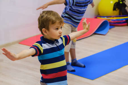 Happy sportsman children exercise in fitness gym.の写真素材