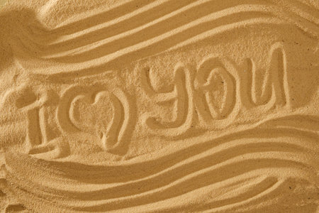Heart in the sand on the beach. Love symboll. Concept with wave and text.