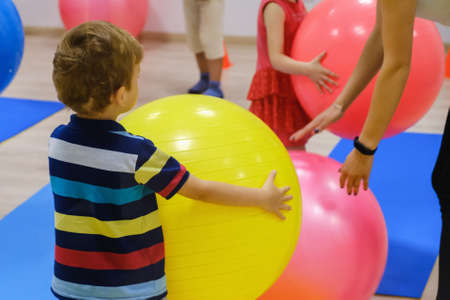 Group of Happy sporty children's exercise with ball in fitness gym.の写真素材