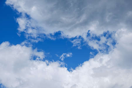 Beautiful blue sky with sunbeams and white clouds. Sun rays.の写真素材
