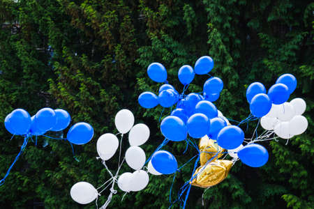 A lot of coloured flyiing balloons in during an holidayの写真素材