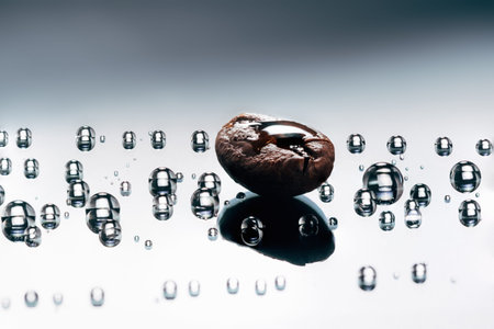 shiny fresh roasted coffee macro beans on glass dark background with water drops close up