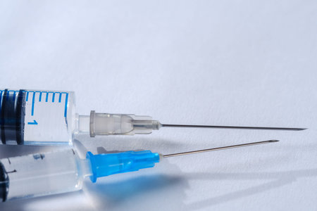 Syringe vaccine and vials, isolated on white background