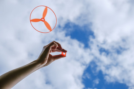 Toy propeller in hand - play with kids on outdoor in summer, launch toy helicopter