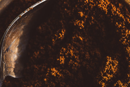ground aromatic fragrant coffee with spoon texture macro beans background