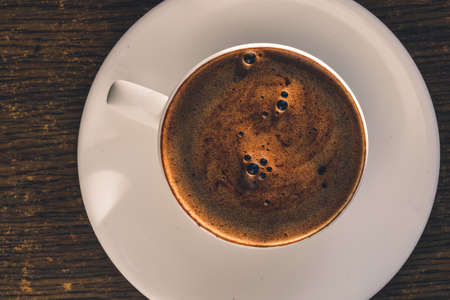 Coffee white cup with foam. Overhead top viewの写真素材