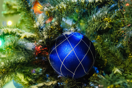 New year Christmas fir tree on the street, decorated with balls and lightsの写真素材