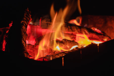 Hot red coals fire with smoke. Texture on a picnic outdoor