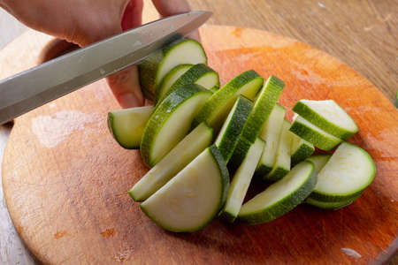 Zucchini cut on board, fresh raw vegetable food,  green.の写真素材