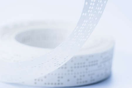 Obsolete data storage technology, old punched tape paper, bit. Obsolete data storage technology, old punched tape paper, bit.