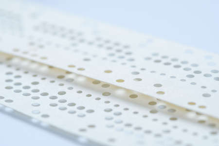 Obsolete data storage technology, old punched tape paper, sd backup. Obsolete data storage technology, old punched tape paper, sd backup.