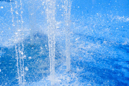 Beautiful view of fountains in a park with green and blue reflection in the water. Summer in park with artificial fountains. Hot Weather concept. Summer time.の写真素材
