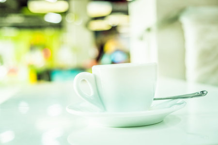Blur image of playground in the mall with coffee cup, use for background.