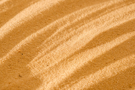 Undulating art flowing wave pattern and concentric circles raked in the sand for wellness and...