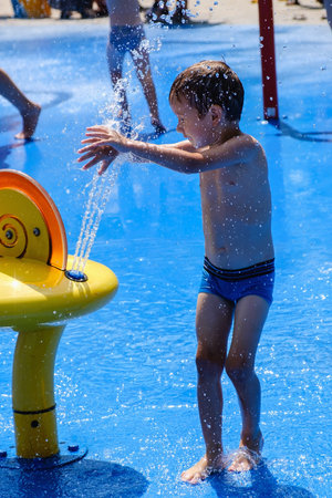 Water in summer, child fun fountain park activity,  outdoor spray.
