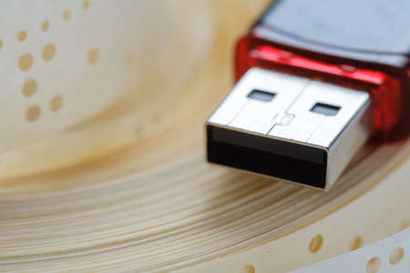 Usb flash drive and obsolete punched tape paper storage, data. Usb flash drive and obsolete punched tape paper storage, data.