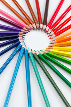Colorful bunch of multicolored vibrant colored pencils on white background closeupの写真素材