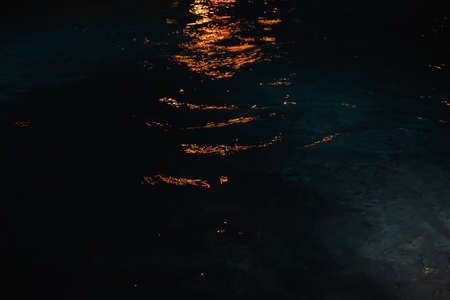 Colorful water ripple light in a pond with bubble bokeh in background. Abstract seaの写真素材