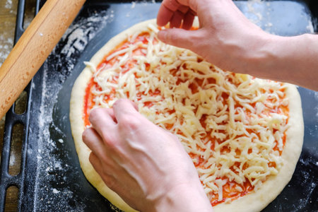 Fresh original Italian raw pizza, preparation in traditional style on a baking tray in the oven