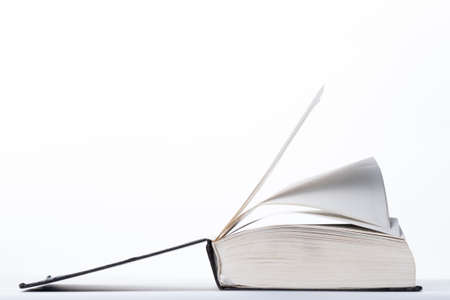 Isolated open book on white surface of the tableの写真素材