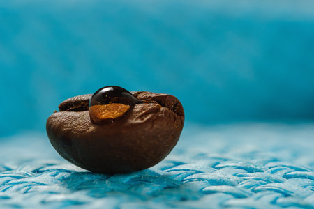 shiny fresh roasted coffee macro beans on woven background close up