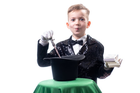 Magician kid illusionist boy in hat, magic show. entertainment trick isolated white backgroundの写真素材