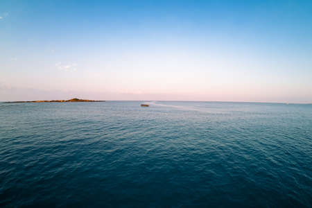 Sunset island blue sky ocean water horizon. sunrise eveningの写真素材