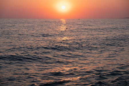 Sunset sea water sun light twilight sky. reflection yellowの写真素材