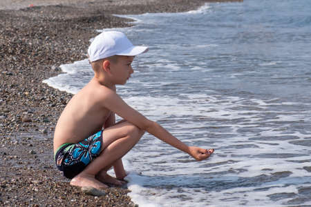 Happy child play in ocean or sea beach, water. young natureの写真素材