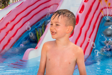 Happy child playing in water pool, fun summer. recreation blueの写真素材