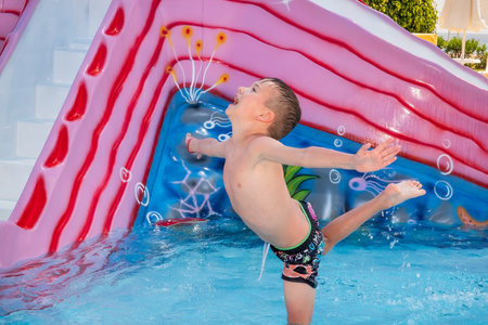 Happy child playing in water pool, fun summer. outdoor recreationの写真素材