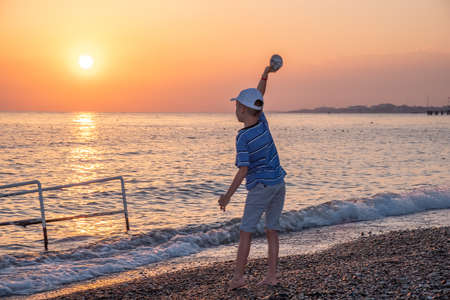 Happy child play sunset ocean sea beach. holiday summerの写真素材