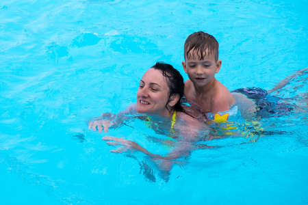 Mother son pool fun family game water. baby summerの写真素材
