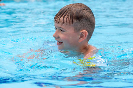 Happy child playing in water pool, fun summer. outdoorの写真素材