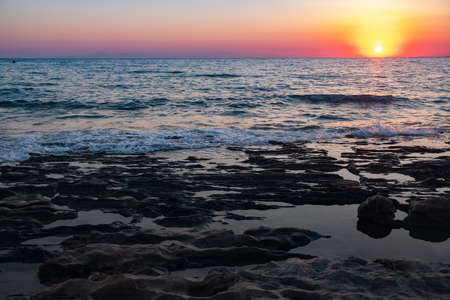Sunset beach ocean wave splash summer storm. rock seascapeの写真素材