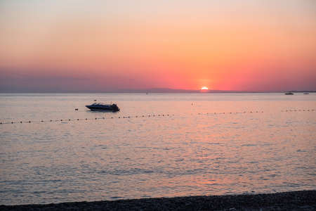 Dusk sea water wave dawn ocean sunrise. red skyの写真素材