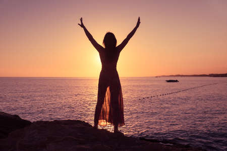 silhouette Happy woman silhouette sea sunset summer ocean. young femaleの写真素材