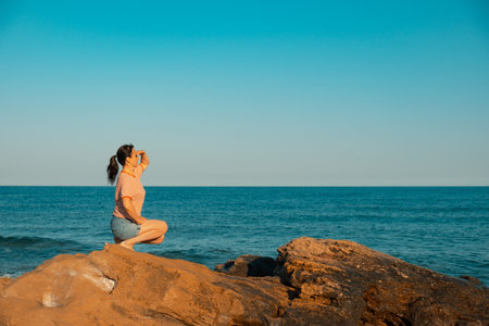 Sea freedom, woman on beach, beautiful girl on rock. nature holidayの写真素材