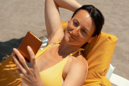 Summer beach, woman with phone, beautiful travel girl. caucasian modelの写真素材